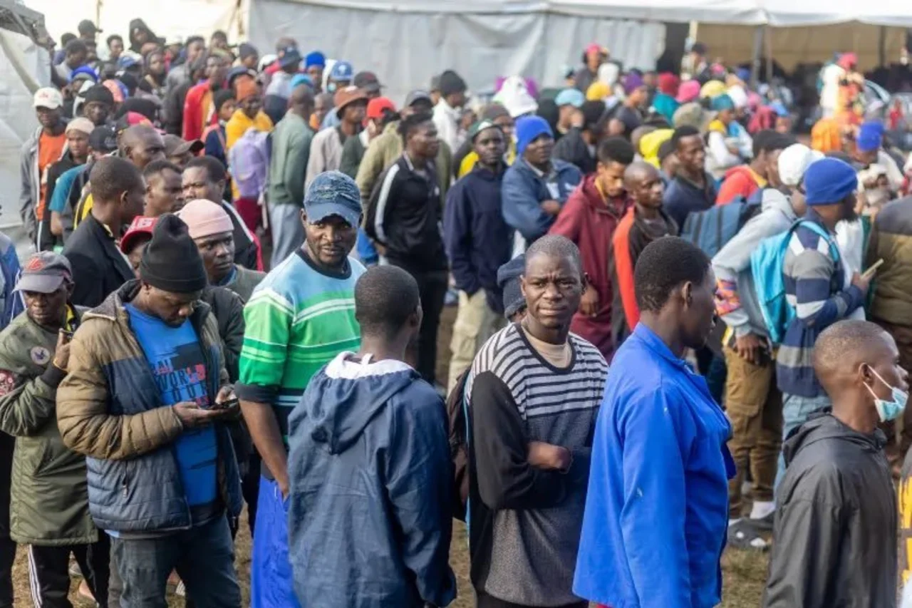 Tensions flare at Durban’s Sherwood Hall as Malawian nationals confront activist Ngizwe Mchunu. Police intervene to prevent violence during voluntary repatriation, with numbers swelling to 6,000 and over 1,100 already processed.